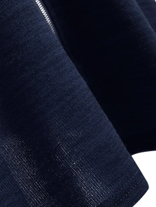 Close-up of deep blue knitted fabric texture with premium silver metal zipper detail
