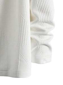 Detail shot of the white jacket featuring premium geometric 3D textured jacquard fabric