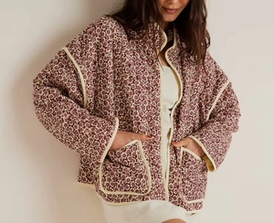 Detail of floral quilted cotton jacket featuring vintage print and diamond stitch texture