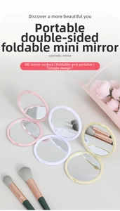 Macro detail of portable folding makeup mirrors in pink, white, and yellow pastel colors