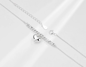Detail of S925 sterling silver heart necklace featuring polished beads and lobster clasp