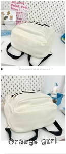 Detail view of white corduroy backpack with black straps and minimalist aesthetic design