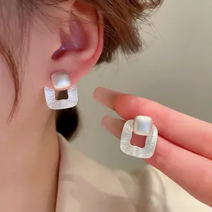 Minimalist square geometric stud earrings with matte silver finish and pearl inlay