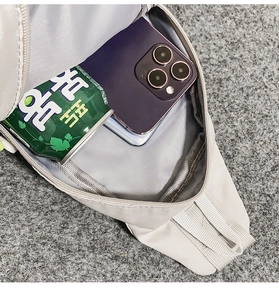 Detailed interior view of the water-resistant gray chest bag showing phone storage capacity