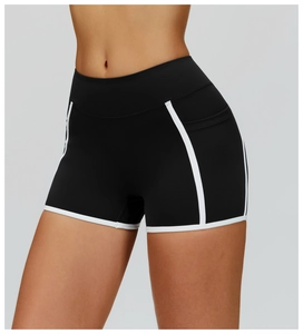 Close-up of black yoga shorts with white trim and a side pocket for workout gear