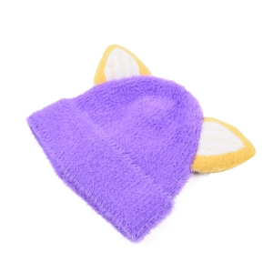 Detail of purple knitted hat with fluffy texture and cute yellow fox ears for kids