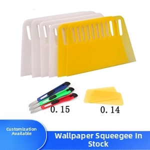 Detail view of plastic scraper tool set with utility knives for wallpaper installation