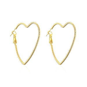 Textured gold heart hoop earrings for women with minimalist metallic finish on white background