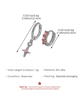 Detail of silver feather earrings with pink crystals and cross pendant showing size specs