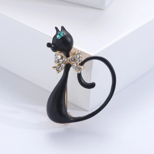 Fashionable black alloy cat brooch with green eyes and a crystal-studded bow tie