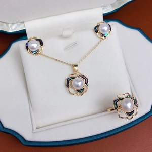 Exquisite gold camellia jewelry set with freshwater pearls and colorful abalone shell in box