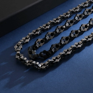 Detailed view of dark grey geometric link chain necklace with textured hip hop style