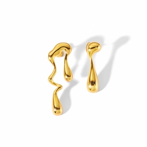 Macro detail of asymmetric 18K gold plated lava drop earrings with liquid metal texture