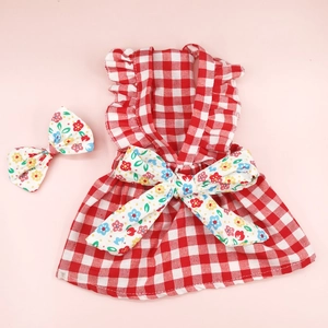 Detailed view of red plaid Christmas dog dress with floral bow and ruffled cotton straps