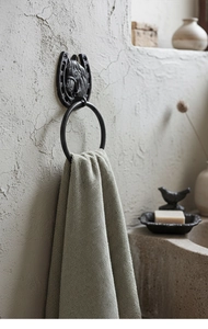Detail view of rustic cast iron horseshoe towel ring with horse head wall mount design