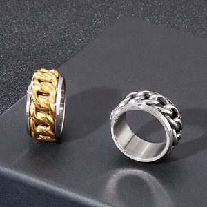 Detail shot of rotatable gold and silver stainless steel chain rings on black display