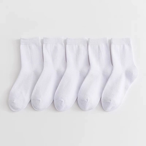 Close-up of five pairs of white cotton mid-calf socks for children on white background