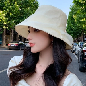 Fashionable beige pleated sun hat for women providing elegant UV protection for summer outings