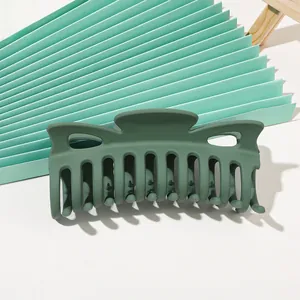 Close-up of matte dark green hair claw clip with non-slip teeth for thick hair