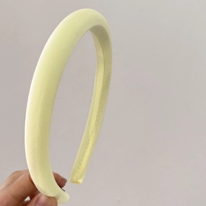 Close-up of a soft pale yellow padded sponge headband with a high-top design