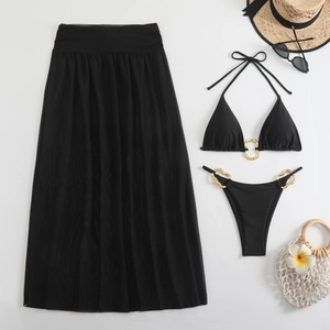 Detailed flat lay of black bikini set with gold metal rings and sheer mesh maxi skirt
