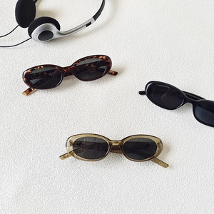 Three pairs of vintage oval sunglasses in black, tortoiseshell and translucent taupe