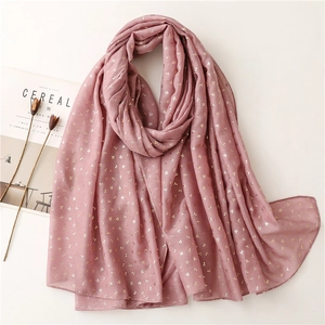 Detail of soft lotus pink scarf featuring gold floral patterns and premium fabric texture