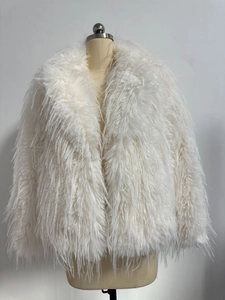 Detail of white faux fur coat featuring shaggy texture and large notched lapels