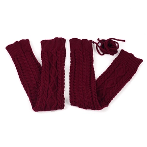 Detailed knit texture of burgundy thigh high leg warmers with cable pattern on white background