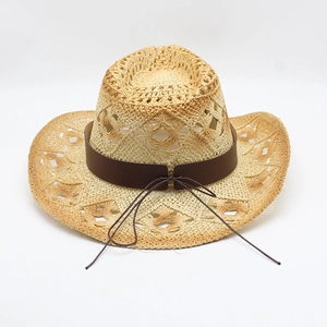 Detail showing the breathable hollow weave and brown ribbon of the straw cowboy hat