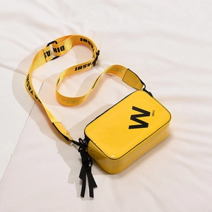 Fashionable bright yellow patent leather crossbody bag with wide black letter print strap