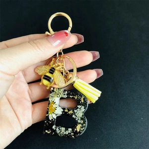 Resin initial B keychain with real dried flowers, gold bee charm and yellow tassel