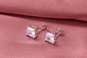 Macro detail of S925 silver square zircon stud earrings with classic 4-claw setting