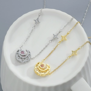 Elegant gold and silver star moon necklace with heart crystal on ceramic cup