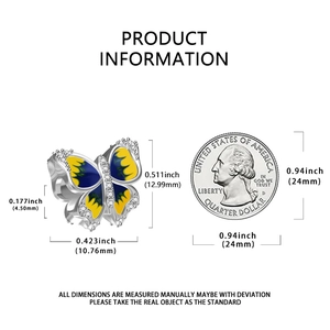 Macro detail of blue butterfly charm with dimensions 12.99mm next to a coin