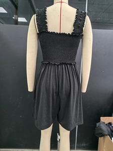 Detail view of the shirred elastic bust and back design on a black sleeveless jumpsuit