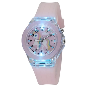 Detail view of pink silicone strap and unicorn dial with blue LED light-up effect