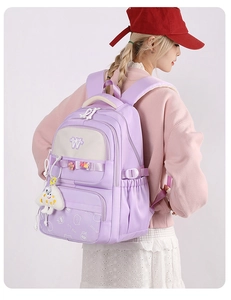 Detail view of purple school backpack with cute bear pattern and cloud charm accessory