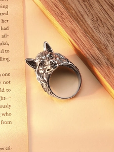 Macro shot of retro wolf head ring showing intricate carved textures and vintage silver finish