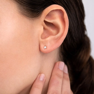 Elegant S925 silver four-leaf clover stud earrings with sparkling cubic zirconia on model