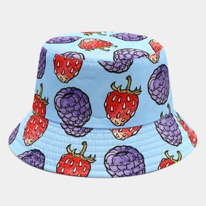 Detail of light blue bucket hat with vibrant strawberry and mulberry print patterns