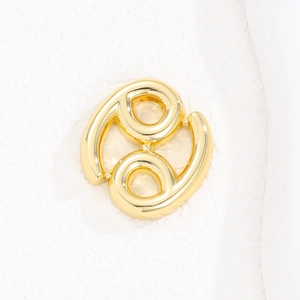 Detailed close-up of a golden puffed bubble Cancer zodiac sign necklace pendant