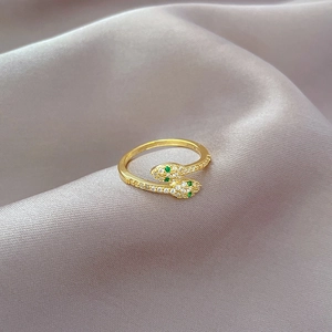 Adjustable gold-plated snake ring with green eye stones and sparkling crystal pavé