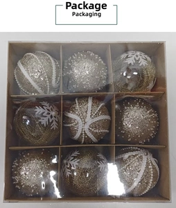 Macro detail of 9-piece gold and silver Christmas ornament set in storage box