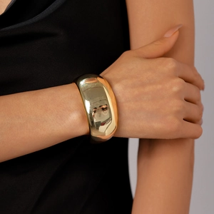 Polished gold wide cuff bracelet with a minimalist geometric open curve design for women