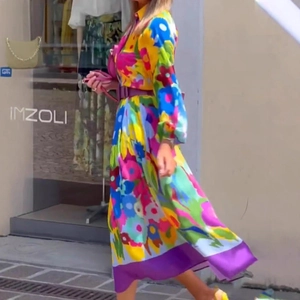 Dynamic view of flowing floral maxi dress with elegant long sleeves and purple belt