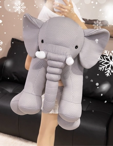 Detail of soft grey elephant plush toy with white dots texture held by a person