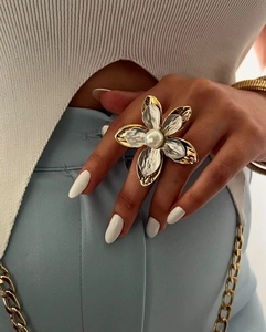 Detail of a large flower statement ring with white petals and a central white pearl inlay