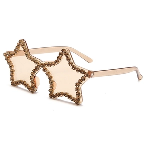 Detailed view of star shaped sunglasses featuring hand set champagne rhinestones and tinted lenses
