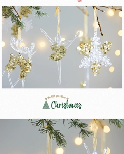 Detail of acrylic Christmas ornaments with gold glitter, reindeer and snowflake hanging